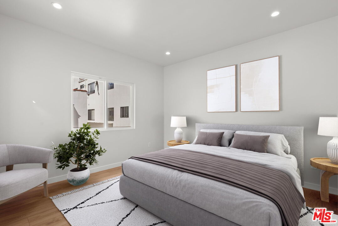 128 South Swall Drive, Unit 1/2 Los Angeles, CA 90048 - Photo 21 of 32 a bedroom with a bed and a potted plant