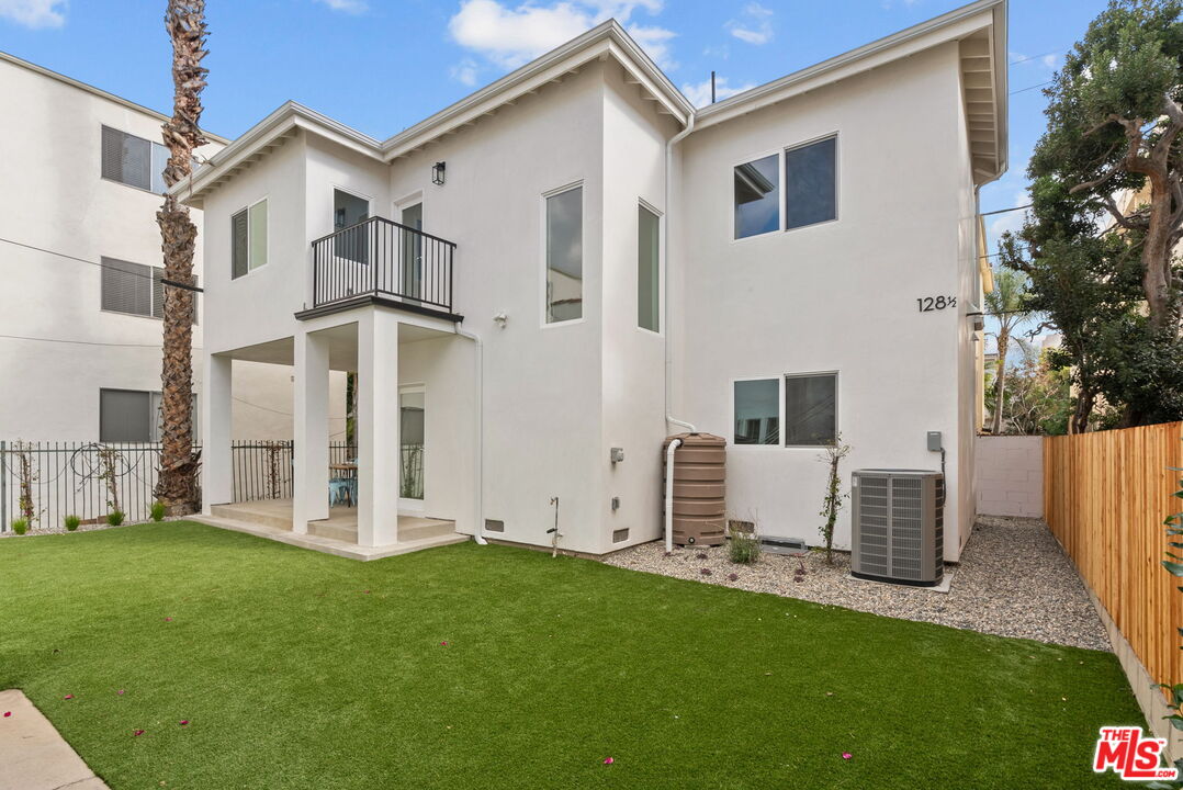 128 South Swall Drive, Unit 1/2 Los Angeles, CA 90048 - Photo 3 of 32 a view of a white house with a yard