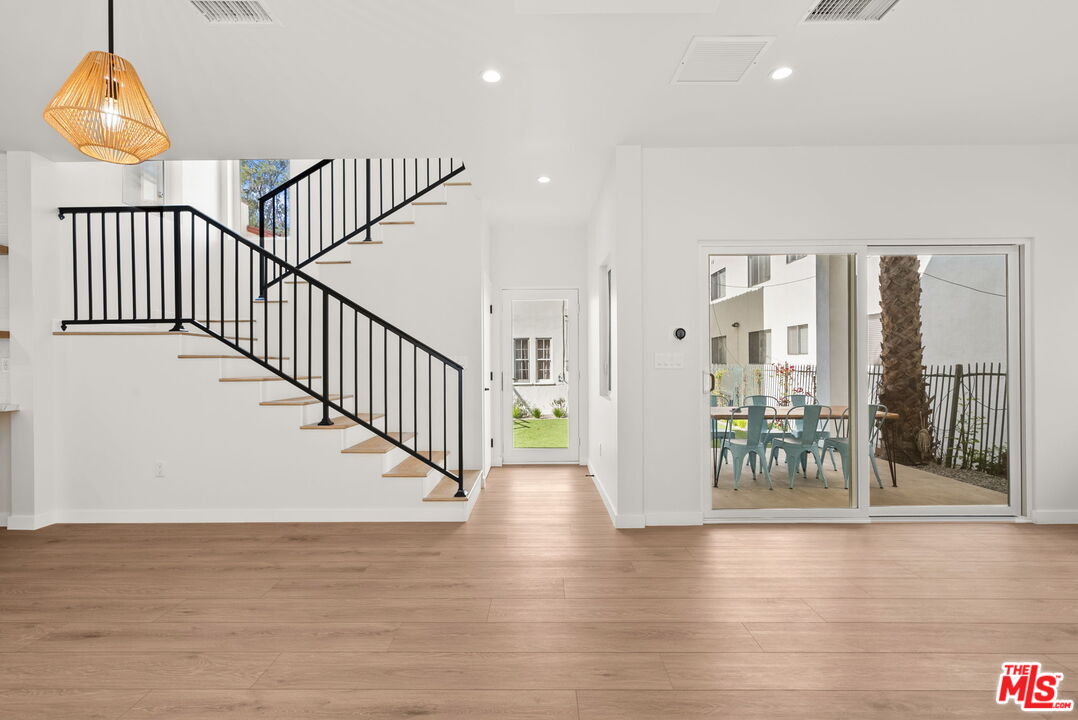 128 South Swall Drive, Unit 1/2 Los Angeles, CA 90048 - Photo 5 of 32 a view of staircase with railing and a chandelier