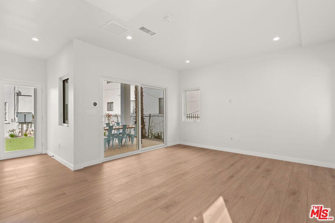 128 South Swall Drive, Unit 1/2 Los Angeles, CA 90048 - Photo 9 of 32 a view of an empty room with wooden floor