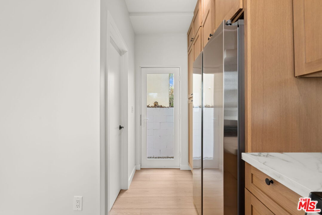 128 South Swall Drive, Unit 1/2 Los Angeles, CA 90048 - Photo 10 of 32 a view of a hallway with wooden floor and a bathroom