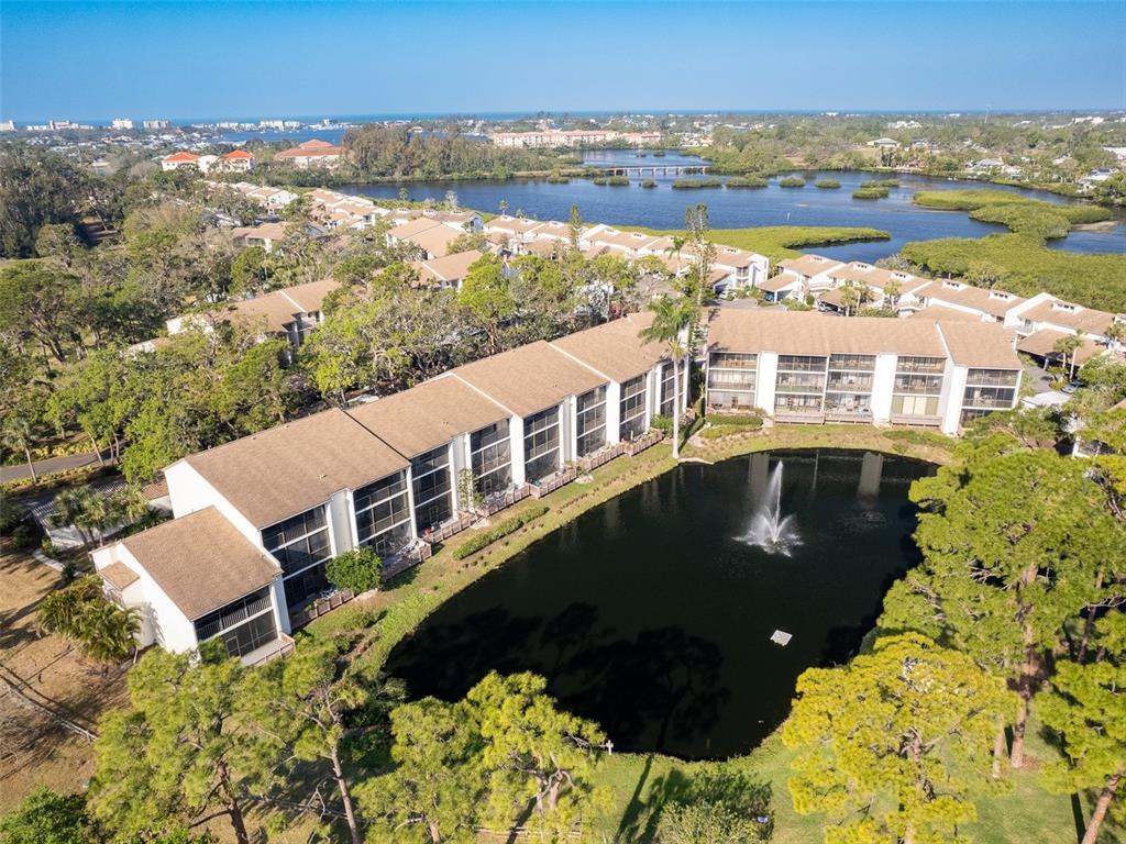 1144 Bird Bay Way, Unit 102 Venice, FL 34285 - Photo 1 of 1 an aerial view of a house with a lake view