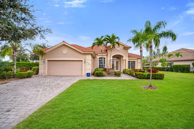 a front view of a house with a yard and garage