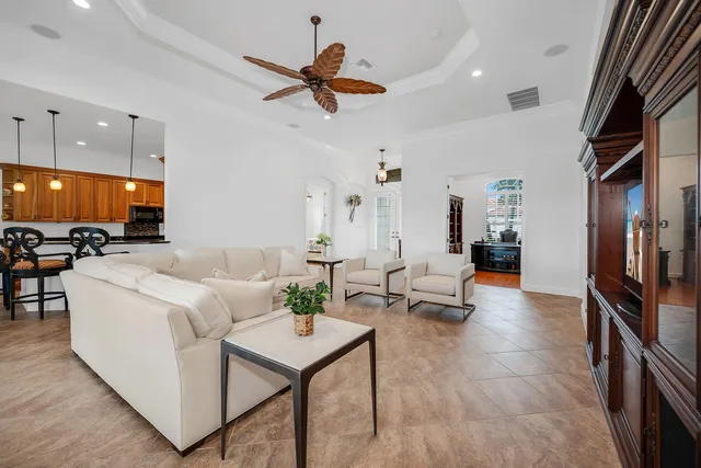 a living room with furniture and kitchen view