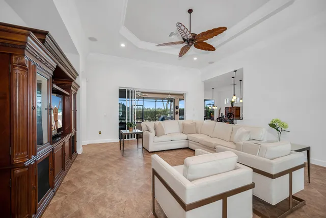 a living room with furniture a ceiling fan and a window