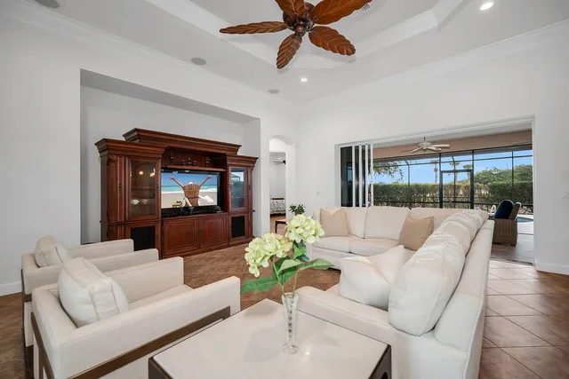 a living room with furniture and a ceiling fan