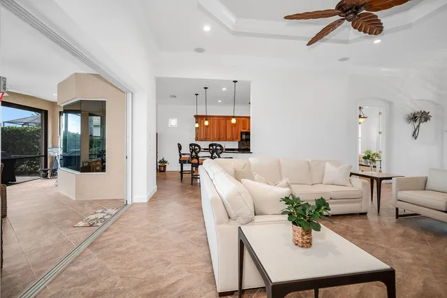 a living room with furniture and a floor to ceiling window