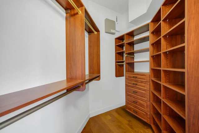 a view of walk in closet with empty racks