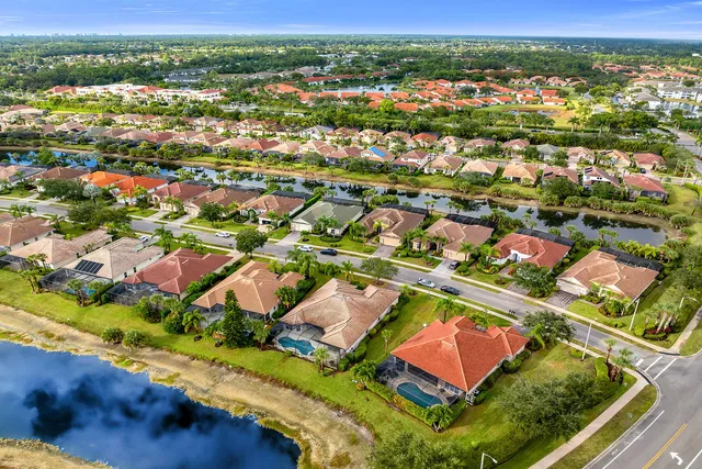 an aerial view of a house with swimming pool and a yard