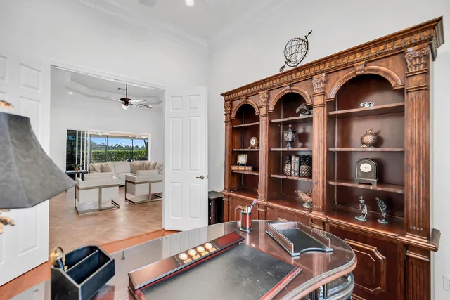 a living room with furniture a rug and a book shelf