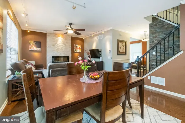 a kitchen with stainless steel appliances granite countertop a stove top oven a sink dishwasher and cabinets with wooden floor