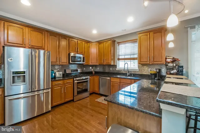 a spacious bathroom with a granite countertop sink and a mirror