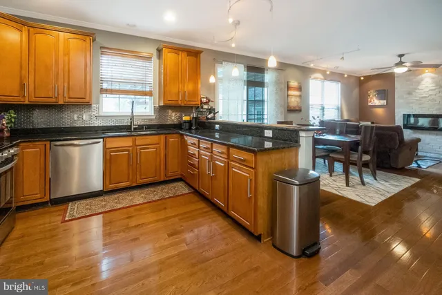 a kitchen with stainless steel appliances granite countertop a refrigerator stove and microwave