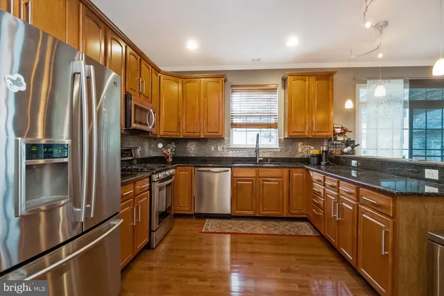 a bathroom with a sink a mirror and a window