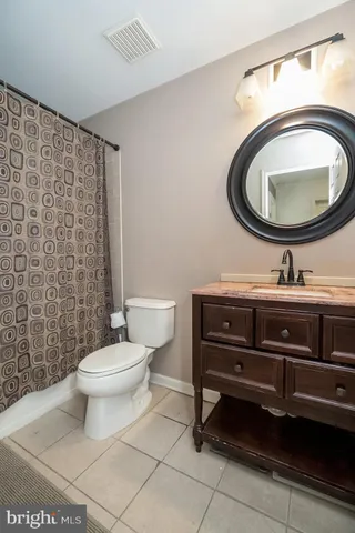 a large bed in a bedroom next to a fireplace