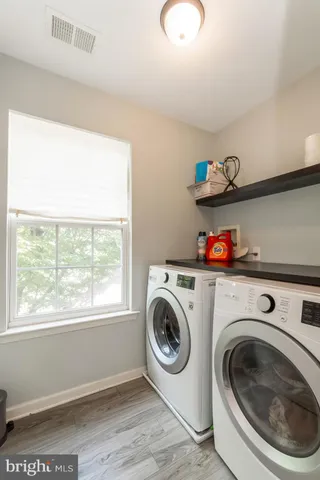 a bathroom with a granite countertop toilet a sink and a mirror