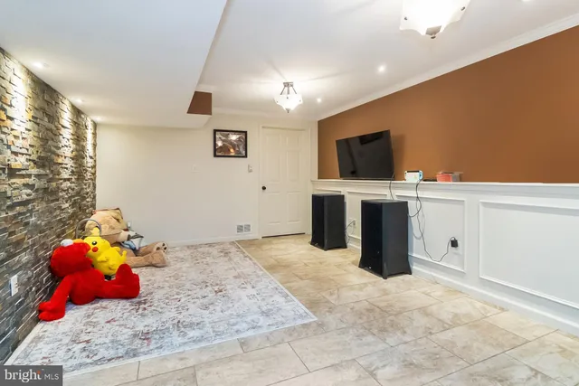 a view of a house with a large window and wooden fence