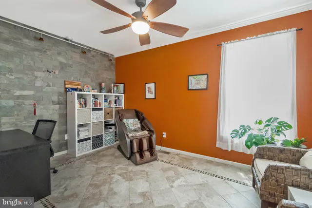 a living room with furniture a flat screen tv and a large window