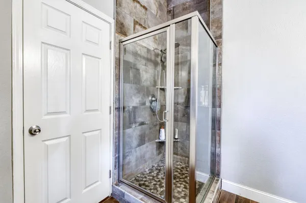 a bathroom with a glass shower door