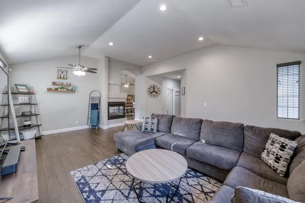 a living room with furniture and wooden floor