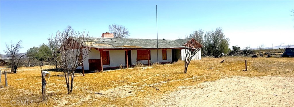 a view of a house with snow on the background