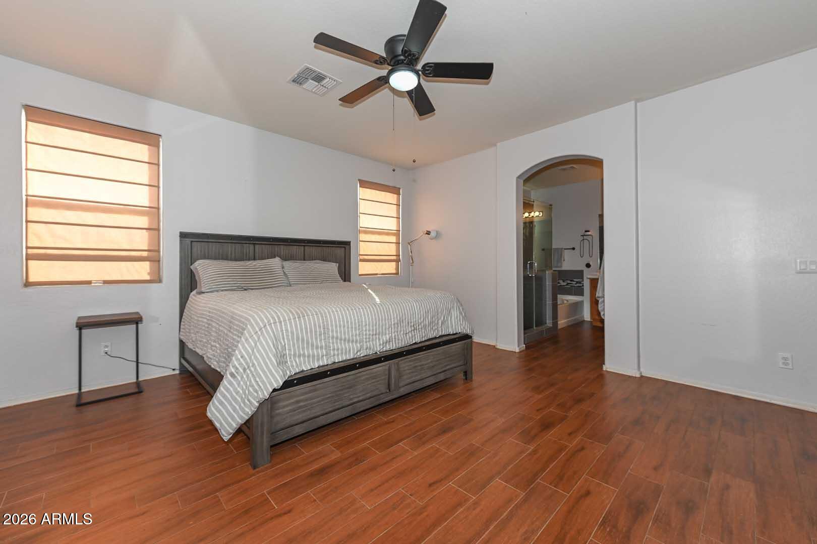 11929 West Alvarado Road Avondale, AZ 85392 - Photo 17 of 39 a bedroom with a bed and a chandelier