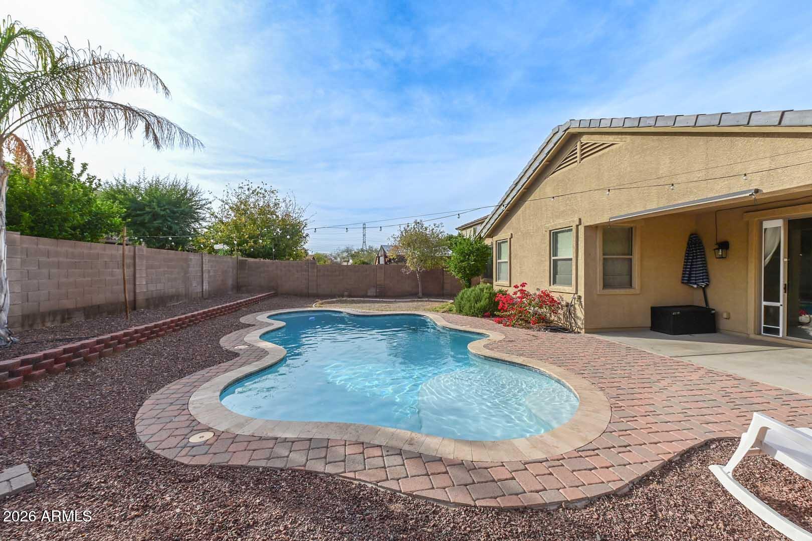 11929 West Alvarado Road Avondale, AZ 85392 - Photo 2 of 39 a view of a house with a swimming pool
