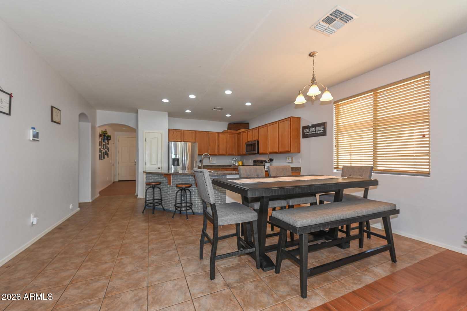 11929 West Alvarado Road Avondale, AZ 85392 - Photo 5 of 39 a view of a a dining room with furniture window and wooden floor