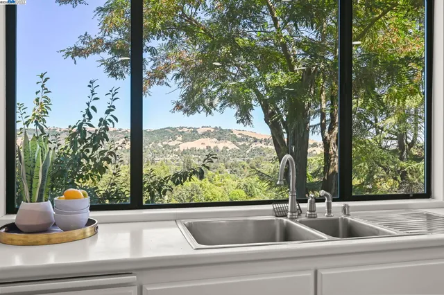 a view of a sink and a table and chairs