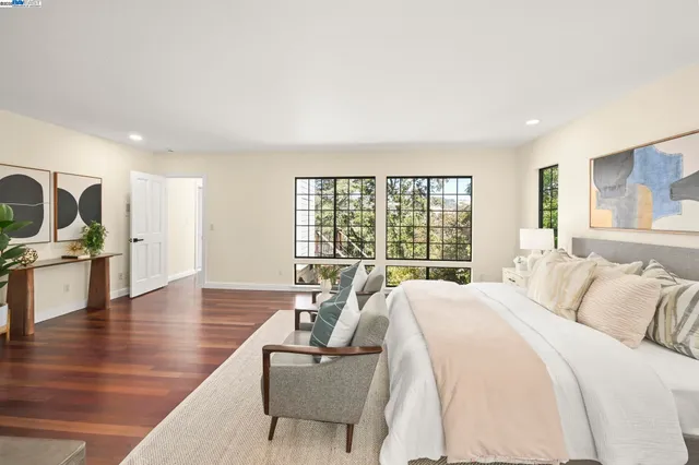 a spacious bedroom with a large bed and a large window