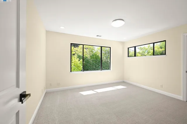 an empty room with windows and view