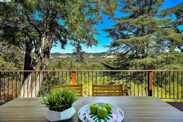a balcony with wooden floor and outdoor seating