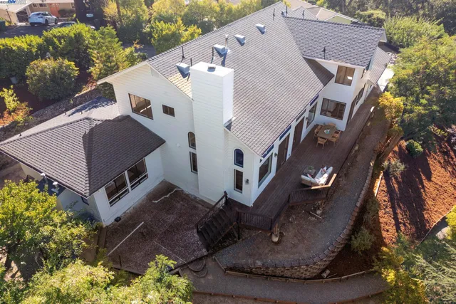 an aerial view of a house with a yard