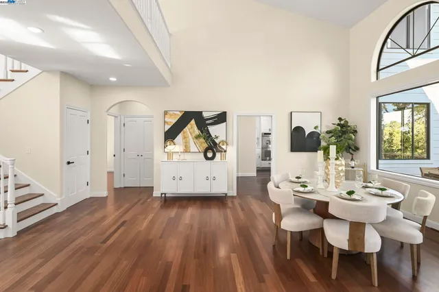 a view of a a dining room with furniture window and wooden floor