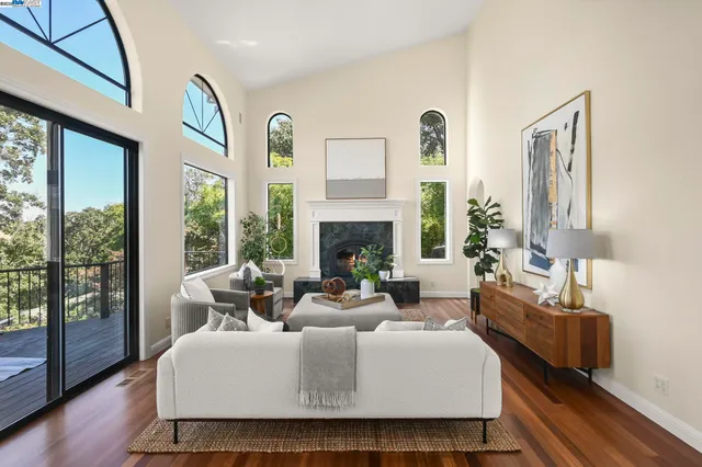 a living room with fireplace furniture and a large window