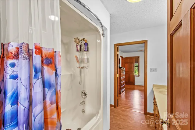 a view of a hallway with wooden floor and glass door