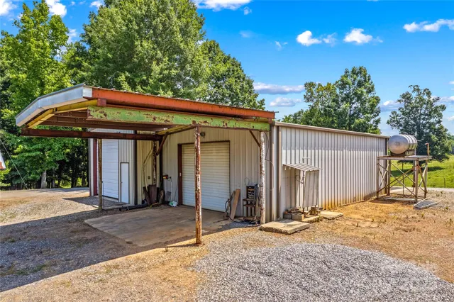 a backyard of a house with table and chairs