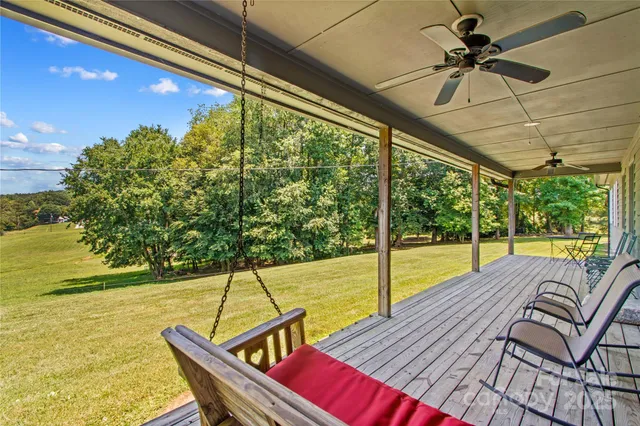 a view of a balcony with chair and wooden floor