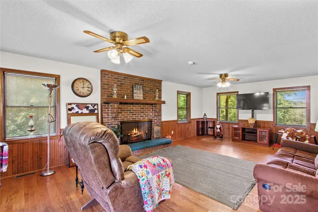 a living room with furniture fireplace and wooden floor