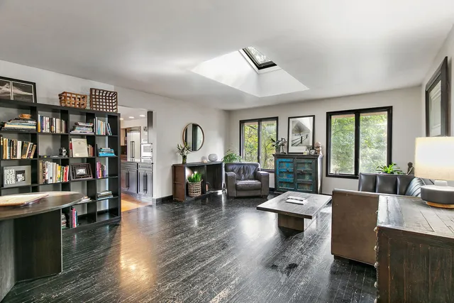 a living room with fireplace furniture and a book shelf