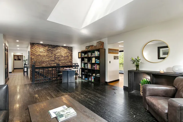 a living room with fireplace furniture and a wooden floor