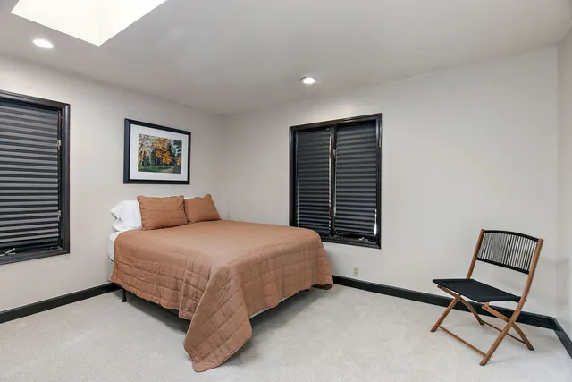 a bedroom with a bed and chair