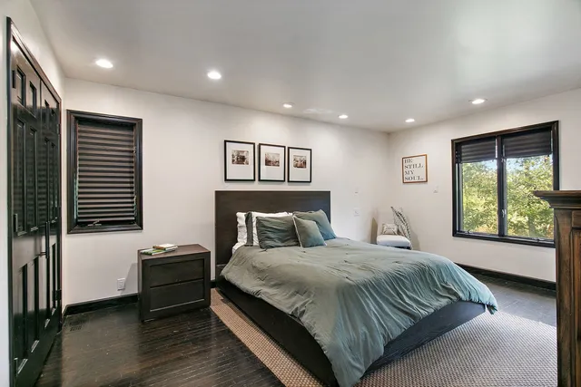 a bedroom with a large bed and a window