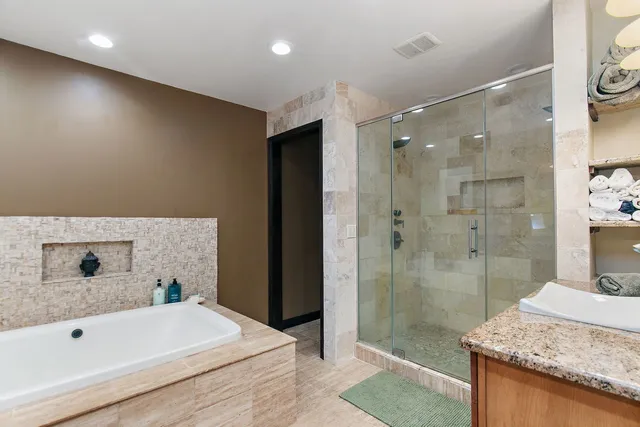 a bathroom with a granite countertop sink mirror and shower