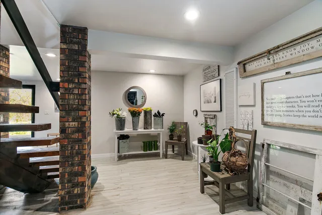 a living room with furniture and a potted plant