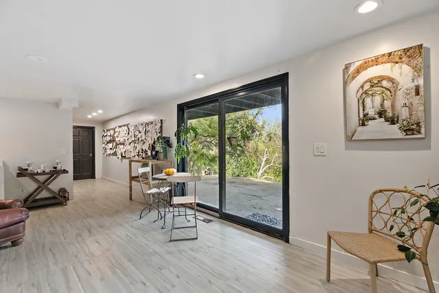 a living room with furniture and large windows