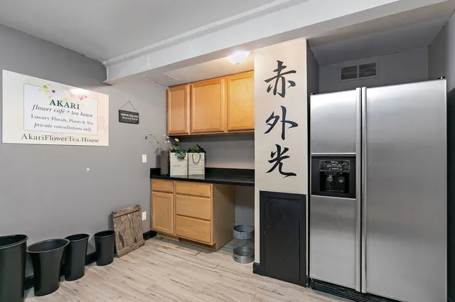a kitchen with stainless steel appliances granite countertop a refrigerator and a stove