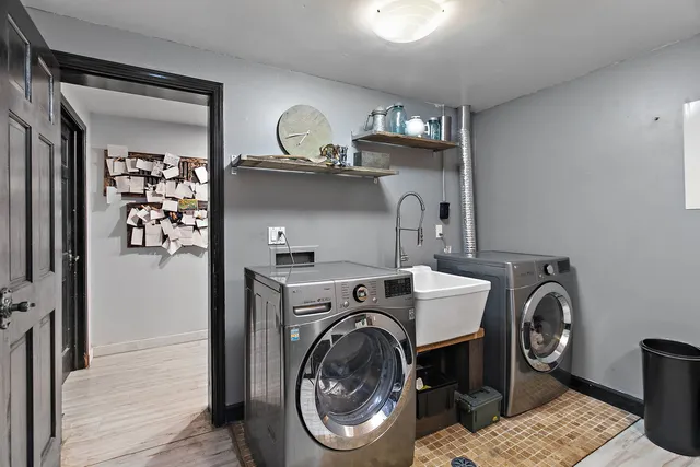 a utility room with sink dryer and washer