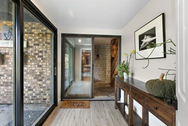 a view of hallway with furniture and wooden floor