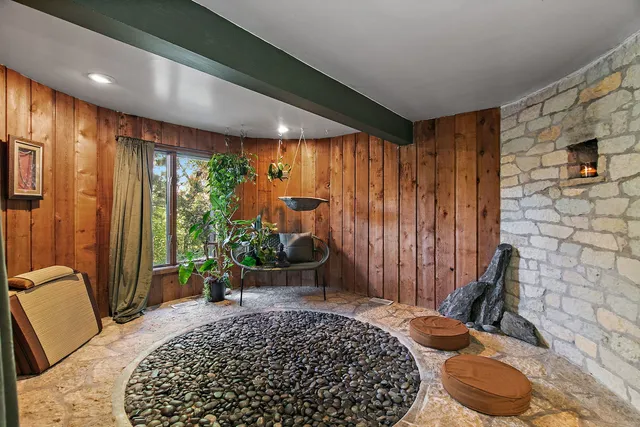 a bedroom with furniture and a large window